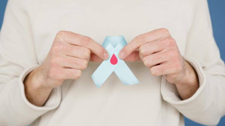 Blood donation helps: The image shows a ribbon with a blood drop depicted on it.